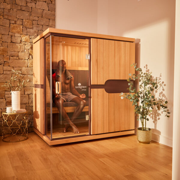 two individuals happily sitting in a Sunlighten sauna