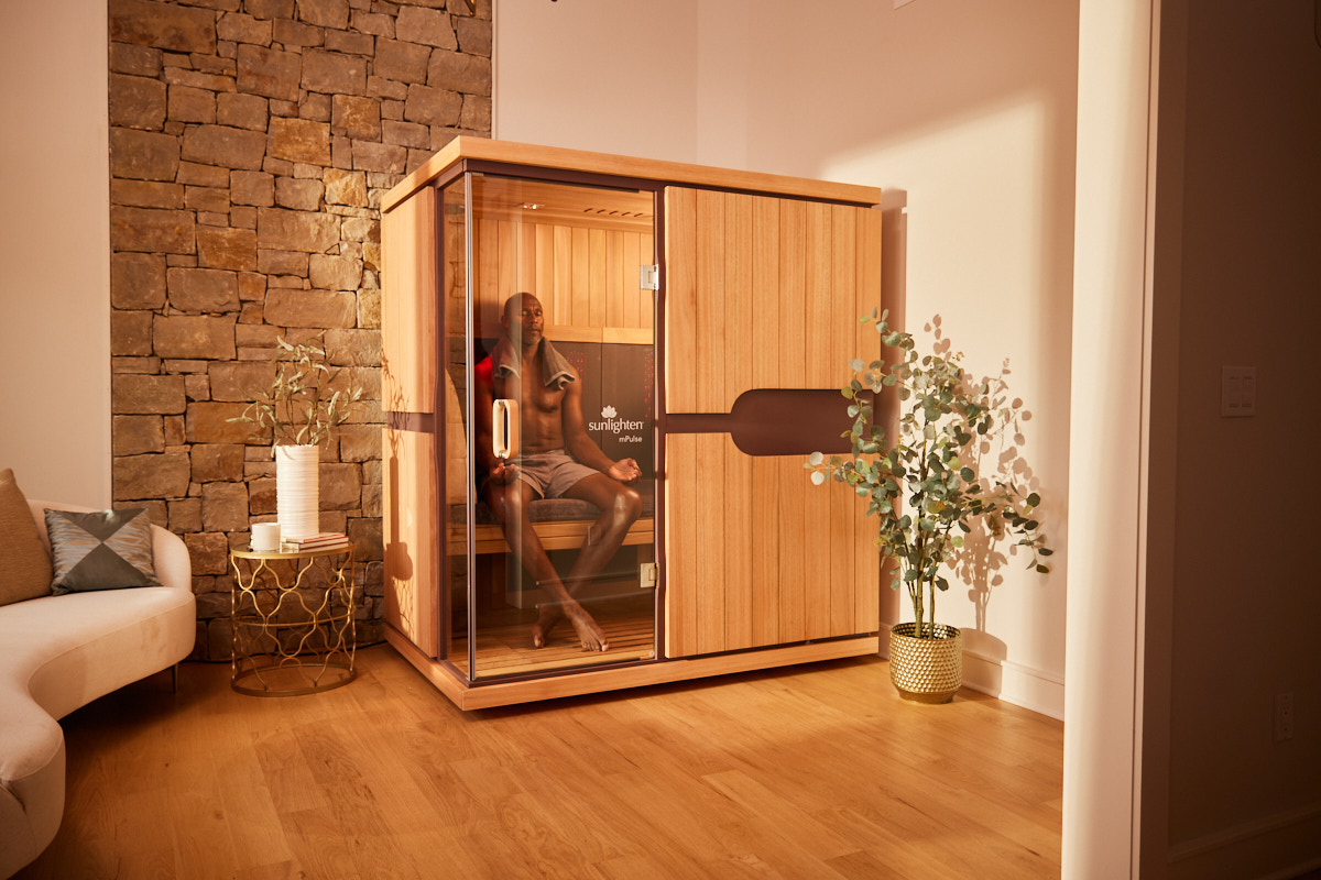 two individuals happily sitting in a Sunlighten sauna